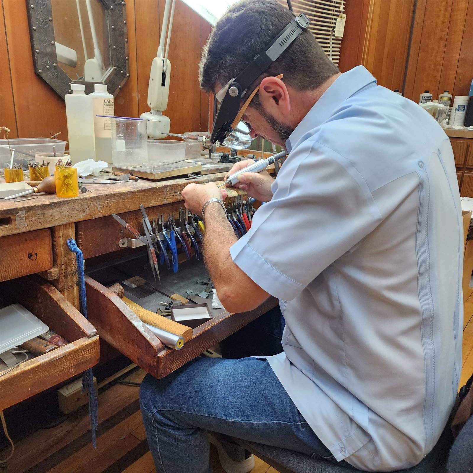 Oscar Munera handcrafting jewelry at his bench in Frederick