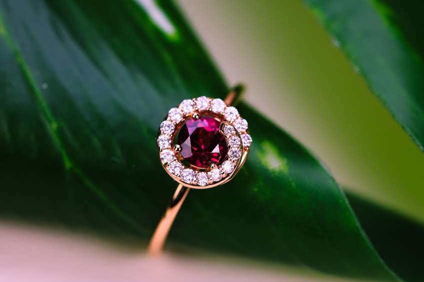 A tourmaline and diamond ring on a leaf